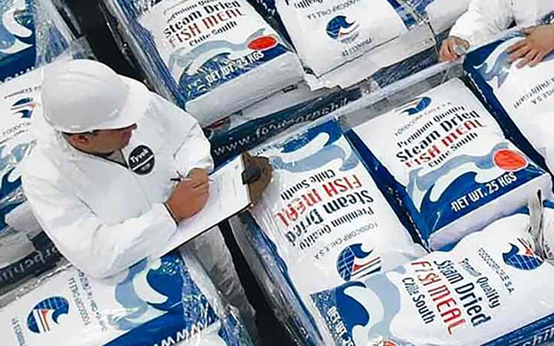 A pile of packaged FoodCorp fishmeal being inspected