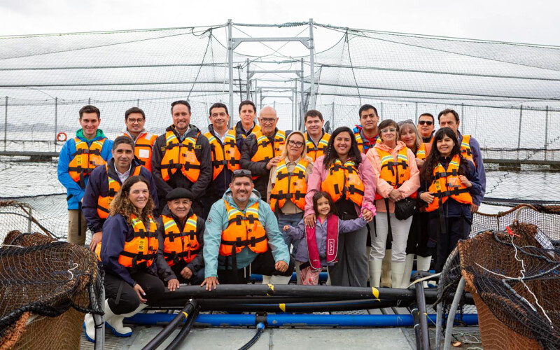 Tourists visiting an AquaChile salmon farm