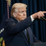 U.S. President Donald Trump pointing at a press conference
