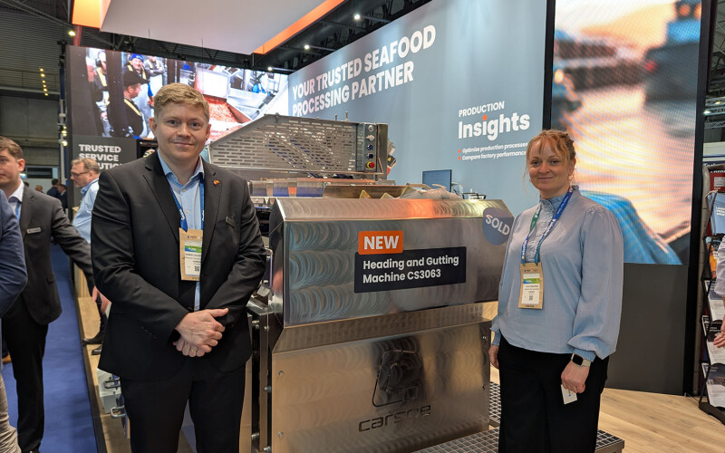 Carsoe Product Sales Manager Rasmus Luca Kronborg and Carsoe Marketing Manager Julie Drustrup pose next to the new heading and gutting machine