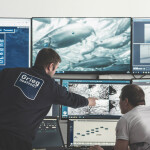 A Grieg Seafood employee in a control panel for a salmon farm