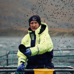 Salmon Scotland Chief Executive Tavish Scott throwing salmon feed