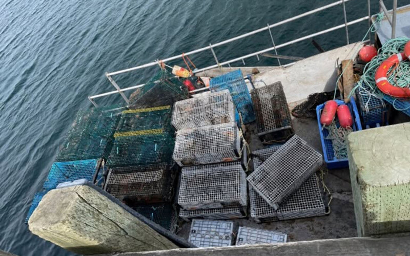 A lobster boat covered in lobster traps