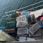 A lobster boat covered in lobster traps