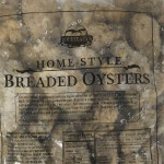A package of frozen breaded oysters with the Boudreaux brand on it