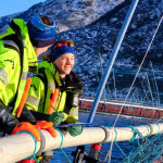 A pair of people on a Norcod net pen