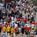 A crowd of soccer fans in front of an Ivar's restaurant
