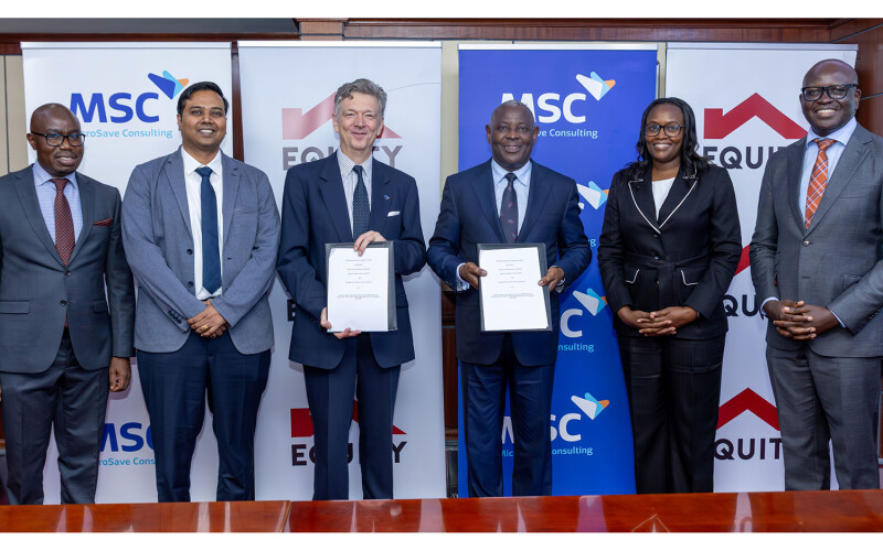 Equity Group Holdings' and MicroSave Consulting's representatives signing the agreement