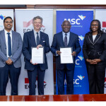 Equity Group Holdings' and MicroSave Consulting's representatives signing the agreement
