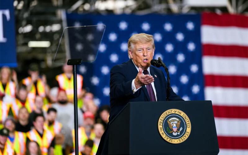 U.S. President Donald Trump giving a speech in front of a flag
