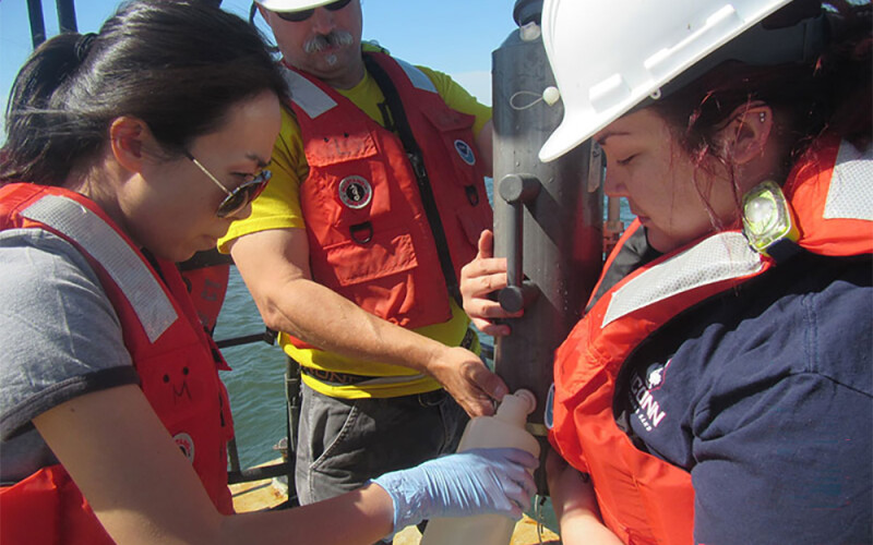 Researchers collect water samples for eDNA