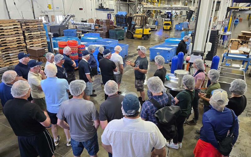 Scottish Fishermen’s Association members standing on a processing facility floor