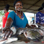 A South Sudanese woman handling fish