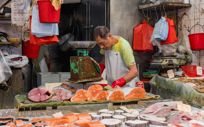 market worker cutting fish