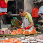 market worker cutting fish