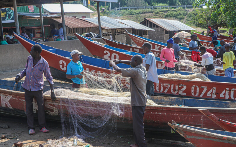 Uganda fishermen untangling a net