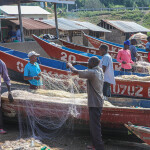 Uganda fishermen untangling a net