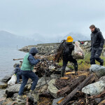A group of volunteers cleaning up trash in a Norwegian fjord