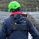 A Sernapesca worker walking on a net pen