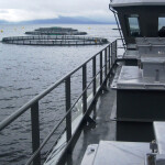 A AKVA Group vessel near some aquaculture net pens