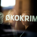The Økokrim logo on a window
