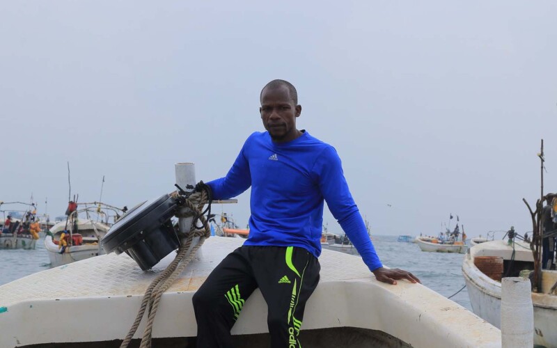 Fisherman in Somalia pulling up nets from the water