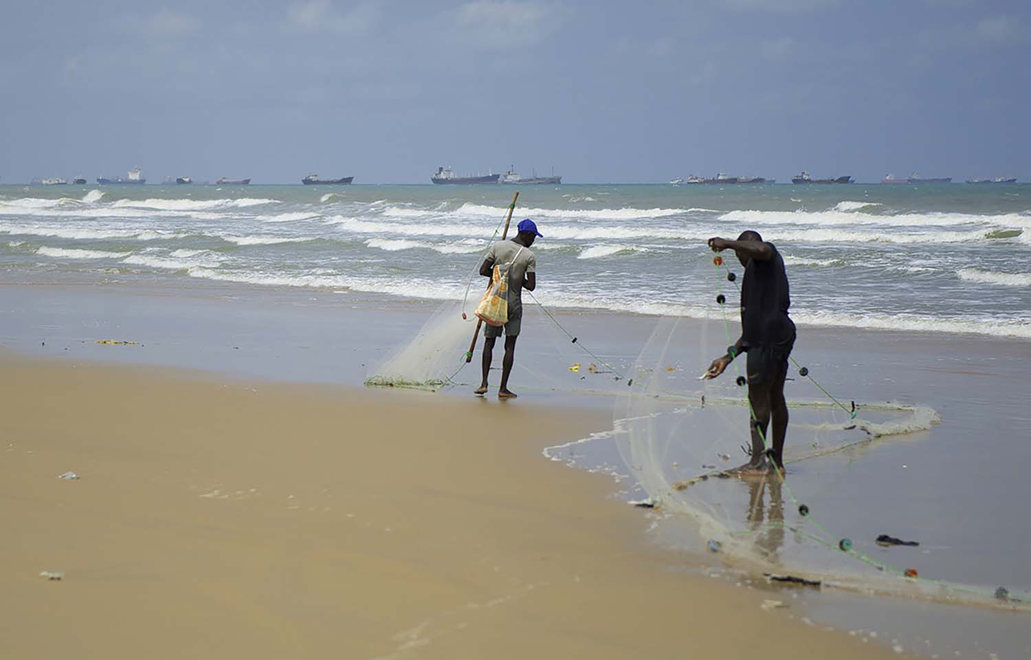 Gabon fishermen hauling in nets on the shore