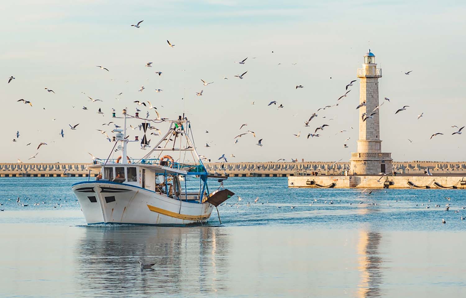 A fishing boat returns to port on the Adriatic Sea off the Italian city of Bari