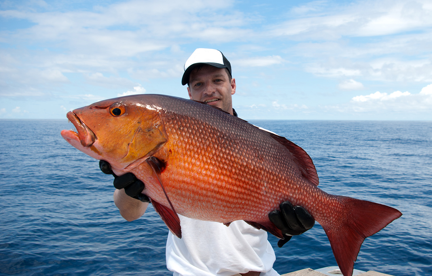 A man holding a red snapper