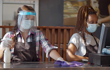 Foodservice workers going about business during the pandemic.