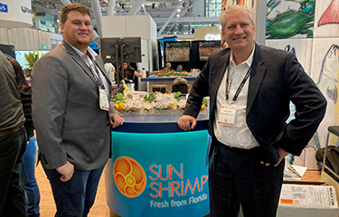 Robin Pearl (right) with his son at the 2023 Seafood Expo North America.