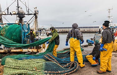 A crew of a U.K. fishing vessel at work.