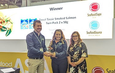 Tassal Head of Sales and Marketing Matt Vince and General Manager of Marketing Libby Williams accepting the trophy from Diversified Communications Vice President of Seafood Wynter Courmont