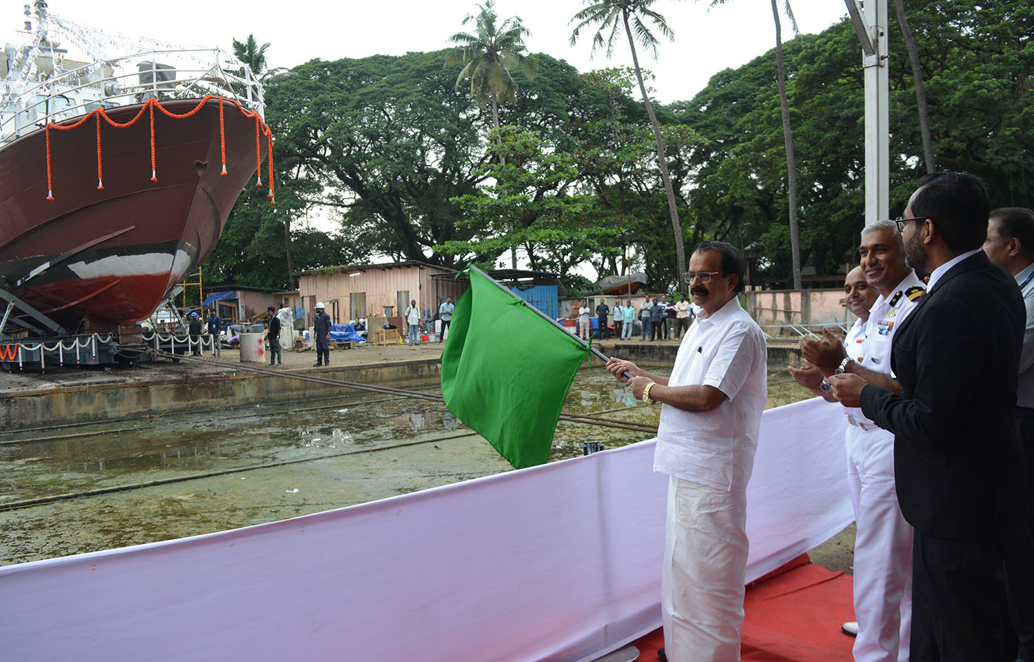 India Union Minister of State for Fisheries George Kurian holding a green flag