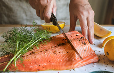 Cutting salmon with lemon