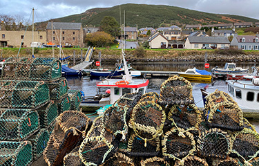 Lobster pots in the harbor in the small coastal village of Helmsdale in Sutherland, on the east coast of Scotland.