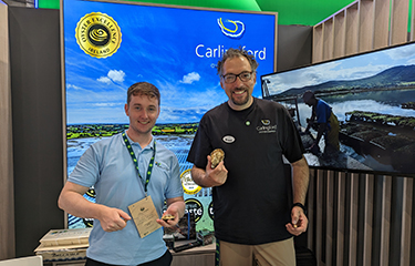 Kian Louët-Feisser poses with an oyster from his farm in Carlingford.