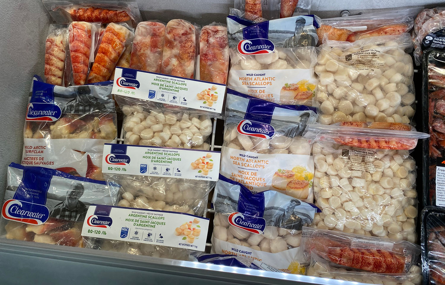 An assembly of Clearwater Seafoods packaged seafood inside a chest freezer