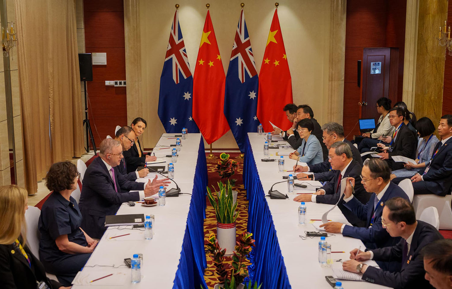 Australian Prime Minister Anthony Albanese at a table across from Chinese Premier Li Qiang during trade meetings in Laos