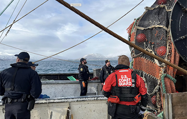 The U.S. Coast Guard and other authorities board an unidentified trawler in Alaska.