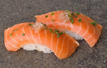 Two pieces of Nigiri sushi, made using Wildtype's cell-based salmon