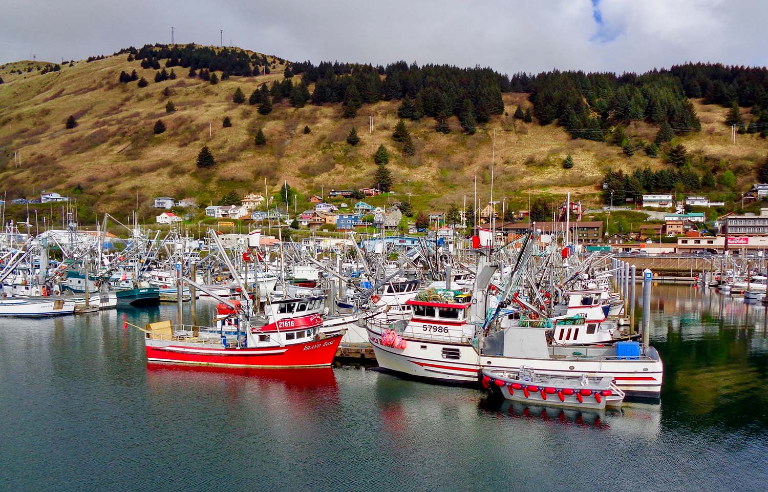 Fishing boats floating at docks in the Kodiak, Alaska harbor.