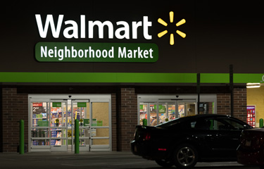 The exterior of a Walmart at night.