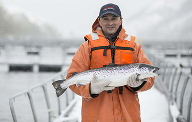 Nova Austral employee with salmon.