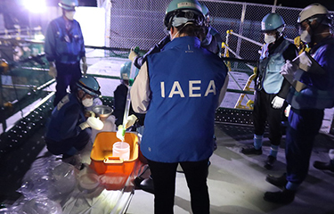 An IAEA inspector oversees water testing at the Fukushima plant.