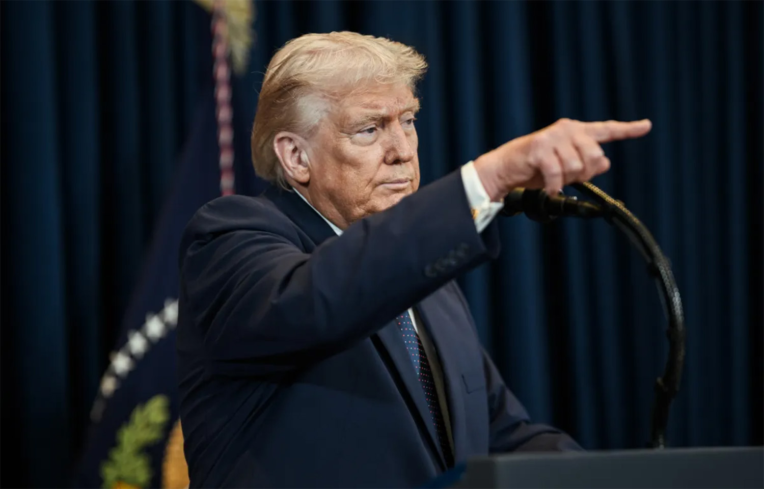 U.S. President Donald Trump pointing at a press conference