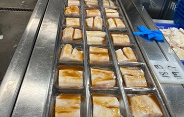 A processing line of Alaskan Leader black cod.